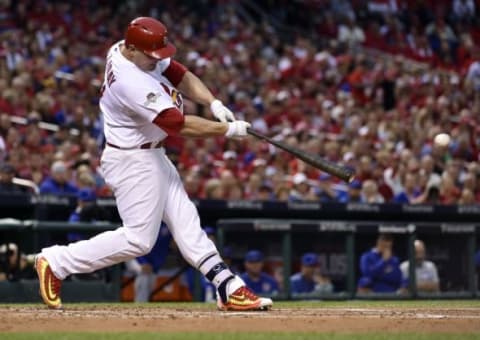 Oct 9, 2015; St. Louis, MO, USA; St. Louis Cardinals left fielder Matt Holliday hits a RBI single against the Chicago Cubs in the first inning in game one of the NLDS at Busch Stadium. Mandatory Credit: Scott Rovak-USA TODAY Sports