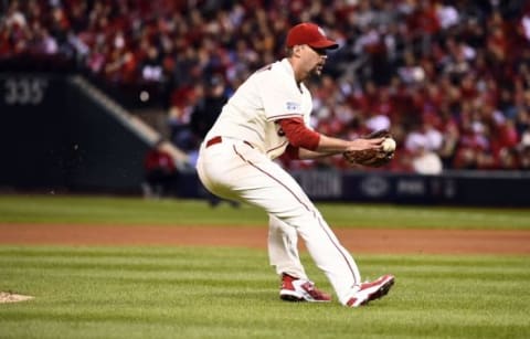 Oct 11, 2014; St. Louis, MO, USA; St. Louis Cardinals starting pitcher Adam Wainwright fields a ground ball in the fifth inning against the San Francisco Giants in game one of the 2014 NLCS playoff baseball game at Busch Stadium. Mandatory Credit: Jasen Vinlove-USA TODAY Sports