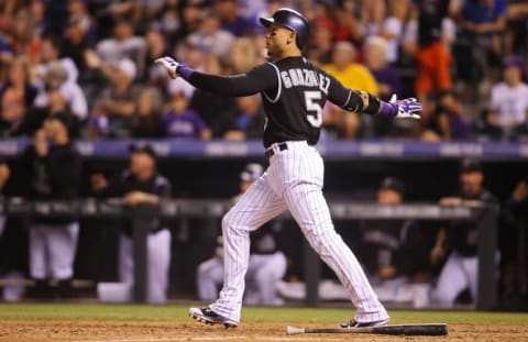 Sep 26, 2015; Denver, CO, USA; Colorado Rockies right fielder Carlos Gonzalez (5) hits a walk off two run home run during the ninth inning against the Los Angeles Dodgers at Coors Field. The Rockies won 8-6. Mandatory Credit: Chris Humphreys-USA TODAY Sports