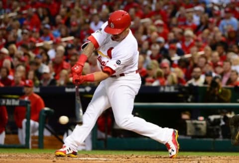 Oct 9, 2015; St. Louis, MO, USA; St. Louis Cardinals second baseman Kolten Wong (16) hits a double during the game against the Chicago Cubs in game one of the NLDS at Busch Stadium. Mandatory Credit: Jeff Curry-USA TODAY Sports