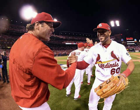 Oct 9, 2015; St. Louis, MO, USA; St. Louis Cardinals outfielder Tommy Pham (60) is congratulated by manager Mike Matheny (22) after the game against the Chicago Cubs in game one of the NLDS at Busch Stadium. Mandatory Credit: Scott Rovak-USA TODAY Sports