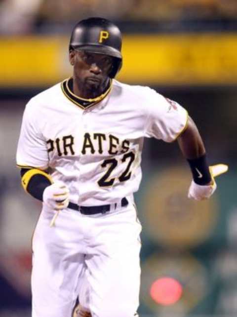 Sep 30, 2015; Pittsburgh, PA, USA; Pittsburgh Pirates center fielder Andrew McCutchen (22) on the base paths against the St. Louis Cardinals during the seventh inning at PNC Park. The Cardinals won 11-1. Mandatory Credit: Charles LeClaire-USA TODAY Sports