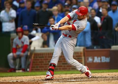 October 13, 2015; Chicago, IL, USA; St. Louis Cardinals first baseman Brandon Moss (21) hits an RBI single in the sixth inning against Chicago Cubs in game four of the NLDS at Wrigley Field. Mandatory Credit: Jerry Lai-USA TODAY Sports