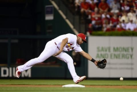 Sep 22, 2015; St. Louis, MO, USA; St. Louis Cardinals shortstop Jhonny Peralta (27) is unable to field a ground ball hit by Cincinnati Reds catcher Brayan Pena (not pictured) during the second inning at Busch Stadium. The Cardinals defeated the Reds 3-1. Mandatory Credit: Jeff Curry-USA TODAY Sports