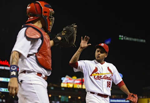 Aug 11, 2015; St. Louis, MO, USA; St. Louis Cardinals starting pitcher Carlos Martinez (18) celebrates with catcher Yadier Molina (4) after getting out of the eighth inning against the Pittsburgh Pirates at Busch Stadium. The Cardinals defeated the Pirates 4-3. Mandatory Credit: Jeff Curry-USA TODAY Sports