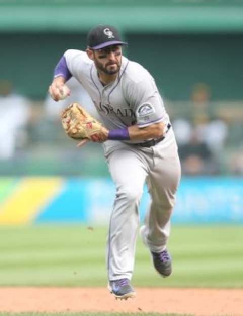 Aug 30, 2015; Pittsburgh, PA, USA; Colorado Rockies shortstop Daniel Descalso (3) throws to first base against the Pittsburgh Pirates during the eighth inning at PNC Park. The Rockies won 5-0. Mandatory Credit: Charles LeClaire-USA TODAY Sports