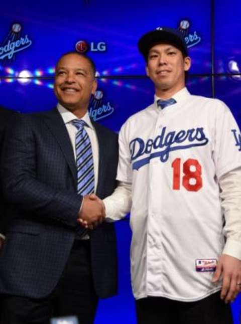 Jan 7, 2016; Los Angeles, CA, USA; Kent Maeda (center) poses with Los Angeles Dodgers manager Dave Roberts (left) at a press conference to announce the signing of the Japanese pitcher to an eight-year contract at Dodger Stadium. Mandatory Credit: Kirby Lee-USA TODAY Sports