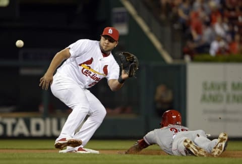 Sep 21, 2015; St. Louis, MO, USA; Cincinnati Reds center fielder Jason Bourgeois (30) advances to second on a wild pitch as St. Louis Cardinals shortstop Jhonny Peralta (27) receives the throw during the first inning at Busch Stadium. Mandatory Credit: Jeff Curry-USA TODAY Sports