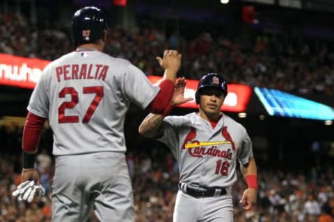 Aug 28, 2015; San Francisco, CA, USA; St. Louis Cardinals shortstop Jhonny Peralta (27) greets second baseman Kolten Wong (16) after they both scored in the fourth inning of their MLB baseball game with the San Francisco Giants at AT&T Park. Mandatory Credit: Lance Iversen-USA TODAY Sports