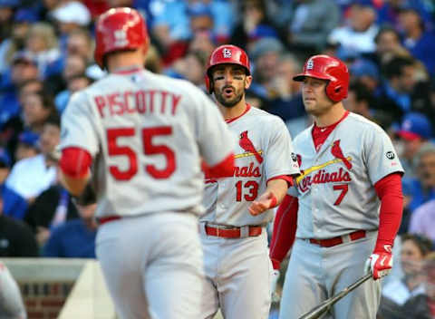 October 13, 2015; Chicago, IL, USA; St. Louis Cardinals left fielder Stephen Piscotty (55) is greeted at home plate by third baseman Matt Carpenter (13) and left fielder Matt Holliday (7) after hitting a two run home run in the first inning against Chicago Cubs in game four of the NLDS at Wrigley Field. Mandatory Credit: Jerry Lai-USA TODAY Sports