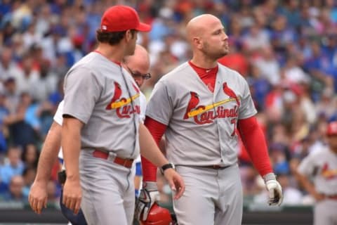 Sep 19, 2015; Chicago, IL, USA; St. Louis Cardinals manager Mike Matheny (26) walks with St. Louis Cardinals left fielder Matt Holliday (7) down the first base line after he is hit by a pitch against the Chicago Cubs at Wrigley Field. Mandatory Credit: Jasen Vinlove-USA TODAY Sports