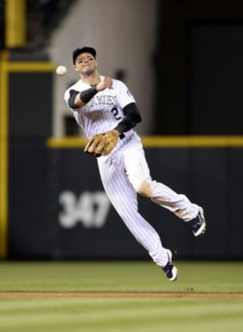 Jun 24, 2015; Denver, CO, USA; Colorado Rockies shortstop Troy Tulowitzki (2) throws back to first base in the eighth inning against the Arizona Diamondbacks at Coors Field. The Diamondbacks defeated the Rockies 8-7. Mandatory Credit: Ron Chenoy-USA TODAY Sports