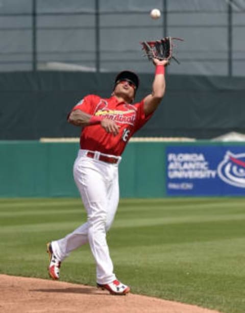 Mar 21, 2016; Jupiter, FL, USA; St. Louis Cardinals second baseman Kolten Wong (16) makes a catch against the Boston Red Sox during the game at Roger Dean Stadium. The Red Sox defeated the Cardinals 4-3. Mandatory Credit: Scott Rovak-USA TODAY Sports