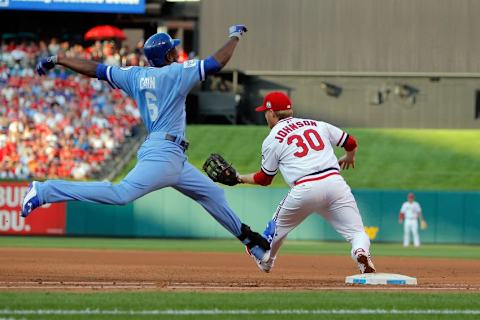 Jul 23, 2015; St. Louis, MO, USA; Kansas City Royals center fielder Lorenzo Cain (6) runs safely at first as St. Louis Cardinals first baseman Dan Johnso (30) waits for the ball during the third inning of a baseball game at Busch Stadium. Mandatory Credit: Scott Kane-USA TODAY Sports