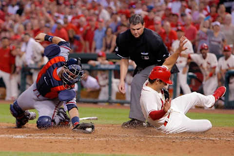 Jul 25, 2015; St. Louis, MO, USA; Atlanta Braves catcher A.J. Pierzynski (15) is unable to put the tag on St. Louis Cardinals shortstop Pete Kozm (38) as he slides home to score a run during the eighth inning of a baseball game at Busch Stadium. Mandatory Credit: Scott Kane-USA TODAY Sports