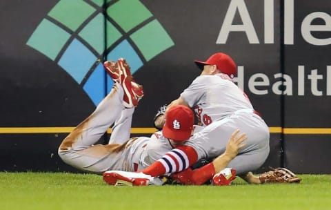 Sep 28, 2015; Pittsburgh, PA, USA; St. Louis Cardinals left fielder Stephen Piscotty (left) and center fielder Peter Bourjos (8) collide making a catch on a ball hit by Pittsburgh Pirates third baseman Josh Harrison (not pictured) during the seventh inning at PNC Park. Piscotty was taken from the game on a stretcher. Mandatory Credit: Charles LeClaire-USA TODAY Sports