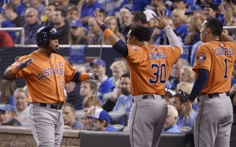 Oct 14, 2015; Kansas City, MO, USA; Houston Astros third baseman Luis Valbuena (18) celebrates with teammates Carlos Gomez (30) and shortstop Carlos Correa (1) after hitting a two-run home run in the 2nd inning against the Kansas City Royals in game five of the ALDS at Kauffman Stadium. Mandatory Credit: John Rieger-USA TODAY Sports