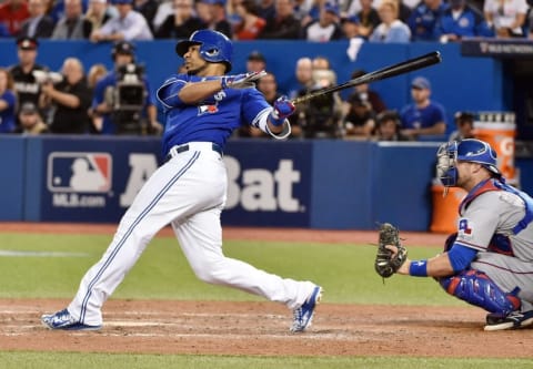 Oct 14, 2015; Toronto, Ontario, CAN; Toronto Blue Jays designated hitter Edwin Encarnacion hits a solo home run against the Texas Rangers in the 6th inning in game five of the ALDS at Rogers Centre. Mandatory Credit: Nick Turchiaro-USA TODAY Sports