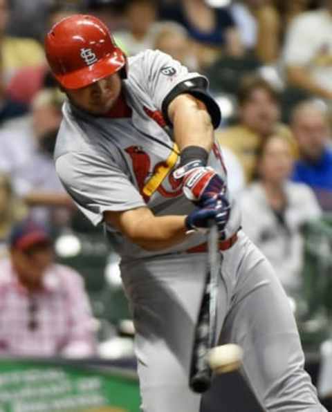 Sep 15, 2015; Milwaukee, WI, USA; St. Louis Cardinals shortstop Jhonny Peralta (27) drives in a run with a base hit in the sixth inning against the Milwaukee Brewers at Miller Park. Mandatory Credit: Benny Sieu-USA TODAY Sports