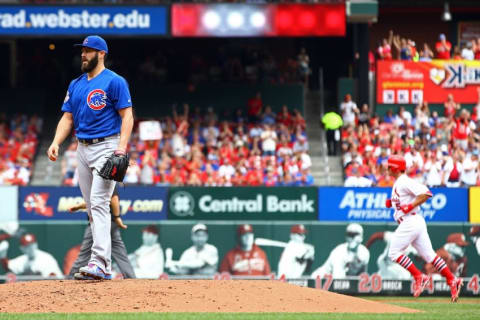 May 25, 2016; St. Louis, MO, USA; Chicago Cubs starting pitcher Jake Arrieta (left) reacts as St. Louis Cardinals center fielder Randal Grichuk rounds the bases after hitting a home run during the second inning at Busch Stadium. Mandatory Credit: Billy Hurst-USA TODAY Sports