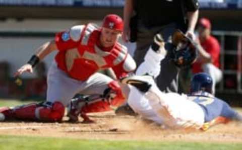 Mar 4, 2016; Kissimmee, FL, USA; Houston Astros outfielder Andrew Aplin (77) is safe at home as St. Louis Cardinals catcher Carson Kelly (82) drops the ball while trying to tag him during the fourth inning at Osceola County Stadium. Mandatory Credit: Butch Dill-USA TODAY Sports