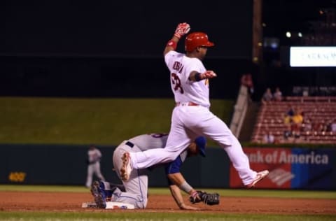 Aug 25, 2016; St. Louis, MO, USA; St. Louis Cardinals catcher Alberto Rosario (68) is ruled safe after New York Mets first baseman James Loney (28) is unable to touch the bag during the eighth inning at Busch Stadium. Mandatory Credit: Jeff Curry-USA TODAY Sports