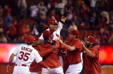 Sep 29, 2016; St. Louis, MO, USA; St. Louis Cardinals catcher Yadier Molina (4) celebrates after hitting a walk off double off of Cincinnati Reds relief pitcher Blake Wood (not pictured) during the ninth inning at Busch Stadium. The Cardinals won 4-3. Mandatory Credit: Jeff Curry-USA TODAY Sports