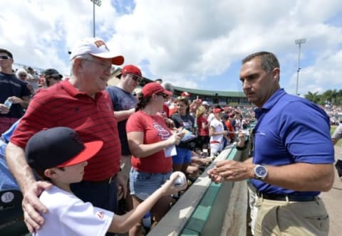 Mar 16, 2015; Jupiter, FL, USA; St. Louis Cardinals general manager Jhn Mozeliak signs an autograph for a young fan before the game against the Detroit Tigers at Roger Dean Stadium. The Cardinals defeated the Tigers 1-0. Mandatory Credit: Scott Rovak-USA TODAY Sports