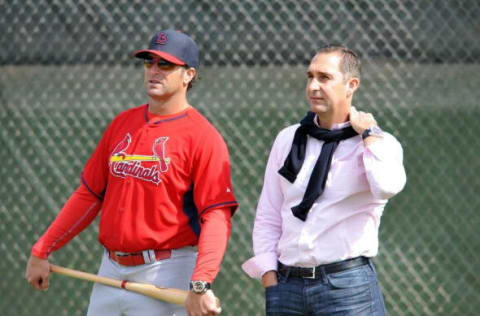 Feb 21, 2015; Jupiter, FL, USA; St. Louis Cardinals manager Mike Matheny (left) talks with Cardinals general manager John Mozeliak (right) during practice drills at Roger Dean Stadium. Mandatory Credit: Steve Mitchell-USA TODAY Sports