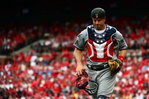 Jul 4, 2016; St. Louis, MO, USA; Pittsburgh Pirates catcher Erik Kratz (38) runs off the field with an American Flag themed chest protector during the first inning against the St. Louis Cardinals at Busch Stadium. Mandatory Credit: Jeff Curry-USA TODAY Sports