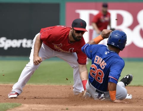 Mar 19, 2015; Jupiter, FL, USA; St. Louis Cardinals third baseman Matt Carpenter (13) tags out New York Mets second baseman Phillip Evans (28) on a stolen base attempt at Roger Dean Stadium. The Mets defeated the Cardinals 7-2. Mandatory Credit: Scott Rovak-USA TODAY Sports