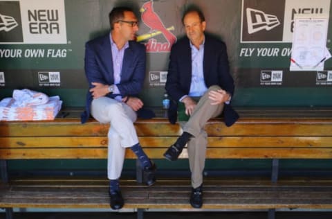 ST. LOUIS, MO – SEPTEMBER 29: St. Louis Cardinals general manager John Mozeliak (L) and Bill DeWitt, Jr. managing partner and chairman of the St. Louis Cardinals talk in the dugout prior to a game against the Chicago Cubs at Busch Stadium on September 29, 2013 in St. Louis, Missouri. The Cardinals beat the Cubs 4-0. (Photo by Dilip Vishwanat/Getty Images)