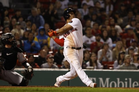 Rafael Devers #11 of the Boston Red Sox hits an RBI single against the Baltimore Orioles. (Photo By Winslow Townson/Getty Images)