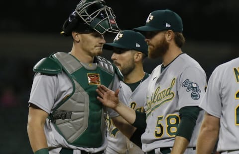 DETROIT, MI – MAY 9: Catcher Sean Murphy #12 of the Oakland Athletics receives a pat on the chest from pitcher Paul Blackburn #58. (Photo by Duane Burleson/Getty Images)