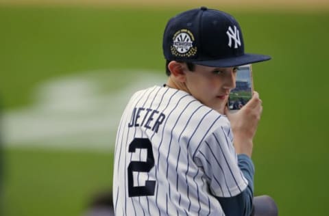 NEW YORK, NY – MAY 14: A young fan waits for former New York Yankees great, Derek Jeter before a pregame ceremony honoring Jeter and retiring his number 2 at Yankee Stadium on May 14, 2017 in New York City. (Photo by Rich Schultz/Getty Images)