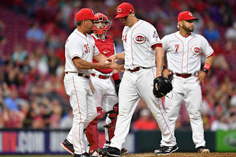 CINCINNATI, OH – MAY 23: Interim Manager Jim Riggleman #35 of the Cincinnati Reds takes the ball as starting pitcher Homer Bailey #34 of the Cincinnati Reds is replaced in the sixth inning against the Pittsburgh Pirates at Great American Ball Park on May 23, 2018 in Cincinnati, Ohio. Pittsburgh defeated Cincinnati 5-4 in 12 innings. (Photo by Jamie Sabau/Getty Images)