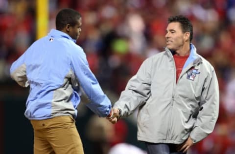 ST LOUIS, MO – OCTOBER 28: Eric Davis Jr (L) and former Cardinal Jim Edmonds deliver the game ball prior to Game Five of the 2013 World Series between the St. Louis Cardinals and the Boston Red Sox at Busch Stadium on October 28, 2013 in St Louis, Missouri. (Photo by Rob Carr/Getty Images)