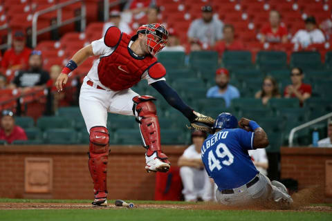 ST. LOUIS, MO – AUGUST 8: Hanser Alberto #49 of the Kansas City Royals is tagged out at home by Andrew Knizner #7 of the St. Louis Cardinals during the ninth inning at Busch Stadium on August 8, 2021 in St. Louis, Missouri. (Photo by Scott Kane/Getty Images)