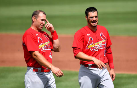 JUPITER, FLORIDA – MARCH 02: Paul Goldschmidt #46 and Nolan Arenado #28 of the St. Louis Cardinals wait for their hat and gloves in between the second inning against the St. Louis Cardinals in a spring training game at Roger Dean Chevrolet Stadium on March 02, 2021 in Jupiter, Florida. (Photo by Mark Brown/Getty Images)