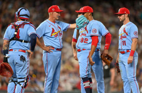 DENVER, CO – JULY 03: Pitching coach Mike Maddux of the St. Louis Cardinals visits Genesis Cabrera #92 on the mound in the seventh inning of a game against the Colorado Rockies at Coors Field on July 3, 2021 in Denver, Colorado. (Photo by Dustin Bradford/Getty Images)