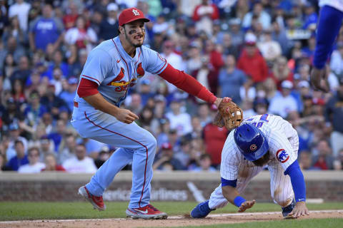 Nolan Arenado #28 of the St. Louis Cardinals tags out David Bote #13 of the Chicago Cubs after being caught in a pickle in the eight inning at Wrigley Field on September 25, 2021 in Chicago, Illinois. (Photo by Quinn Harris/Getty Images)