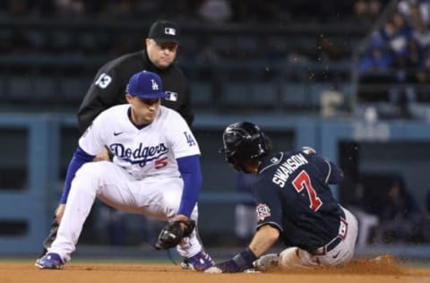 LOS ANGELES, CALIFORNIA – OCTOBER 20: Dansby Swanson #7 of the Atlanta Braves slides safely into second base avoiding a tag by Corey Seager #5 of the Los Angeles Dodgers during the ninth inning of Game Four of the National League Championship Series at Dodger Stadium on October 20, 2021 in Los Angeles, California. (Photo by Sean M. Haffey/Getty Images)