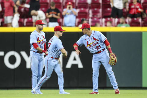 Dylan Carlson #3, Tyler O’Neill #27 and Lars Nootbaar #21 of the St. Louis Cardinals celebrate after beating the Cincinnati Reds 6-3 at Great American Ball Park on July 23, 2022 in Cincinnati, Ohio. (Photo by Lauren Bacho/Getty Images)