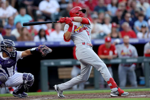 DENVER, COLORADO – AUGUST 10: Lars Nootbaar #21 of the St Louis Cardinals hits a RBI sacrifice fly against the Colorado Rockies. (Photo by Matthew Stockman/Getty Images)