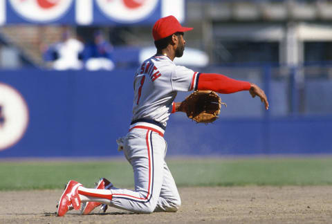 Ozzie Smith #1 of the St. Louis Cardinals throws to second base from his knees against the New York Mets during a Major League baseball game circa 1989 at Shea Stadium in the Queens borough of New York City. Smith played for the Cardinals from 1982-96. (Photo by Focus on Sport/Getty Images)