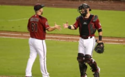 PHOENIX, AZ – JULY 22: Relief pitcher Silvino Bracho #61 and catcher Jeff Mathis #2 of the Arizona Diamondbacks celebrate after defeating the Colorado Rockies 6-1 in the MLB game at Chase Field on July 22, 2018 in Phoenix, Arizona. (Photo by Christian Petersen/Getty Images)