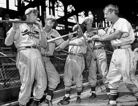 Four players from the St Louis Cardinals baseball team, nicknamed the ‘Gashouse Gang,’ as they clown around on the field, 1937. Pictured are members of the so-called ‘Muscat Band,’ from left, Bob ‘Lefty’ Weiland (1905 – 1988), Lon Warneke (1909 – 1976), Stanley ‘Frenchy’ Bordagaray (1910 – 2000), Bill ‘Fiddler’ McGee (1909 – 1987), and Pepper Martin (1904 – 1965), as they use baseball bats as musical instruments. (Photo by Irving Haberman/IH Images/Getty Images)