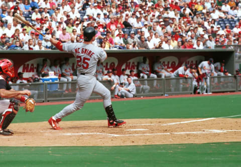 St. Louis Cardinal Mark McGwire watches as his 61st homer of the season sails in to the red seats 27 September, 1999, at Cinergy Field in Cincinnati, OH in a game against the Reds. The Cards lost 7-9. AFP Photo/Mark A. Stahl (Photo by – / AFP) (Photo by -/AFP via Getty Images)