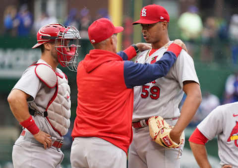 CHICAGO, ILLINOIS – JUNE 04: Pitching coach Mike Maddux #35 of the St. Louis Cardinals talks with Johan Oviedo #59 of the St. Louis Cardinals during the first inning of Game One of a doubleheader against the Chicago Cubs at Wrigley Field on June 04, 2022 in Chicago, Illinois. The Cubs defeated the Cardinals 6-1. (Photo by Nuccio DiNuzzo/Getty Images)