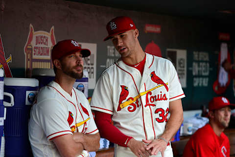 Sep 22, 2018; St. Louis, MO, USA; St. Louis Cardinals pitcher Jack Flaherty (32) talks with starting pitcher Adam Wainwright (50) during the seventh inning against the San Francisco Giants at Busch Stadium. Mandatory Credit: Jeff Curry-USA TODAY Sports